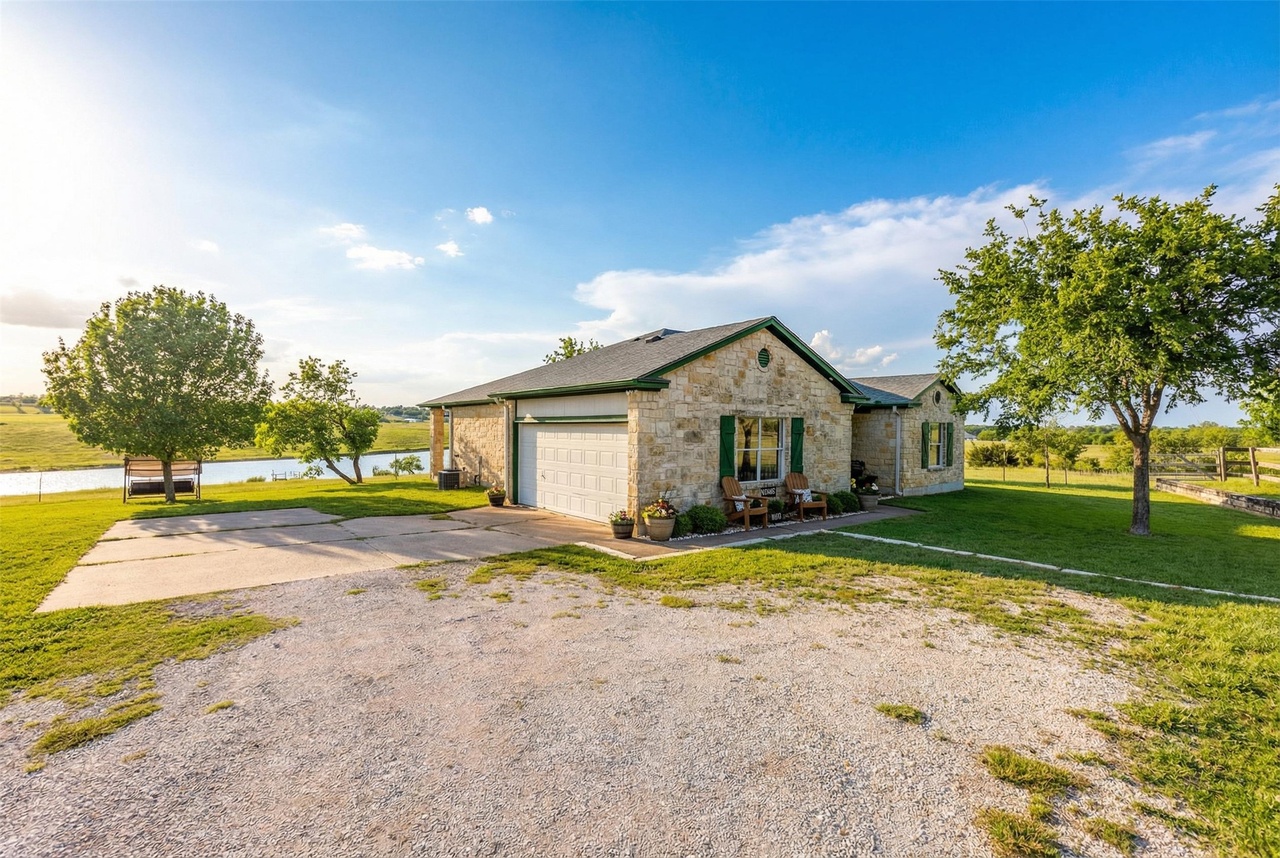 Stone home front exterior with lake in background